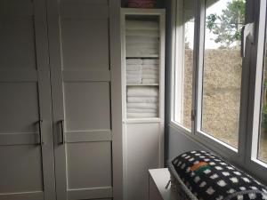 a closet with white cabinets and a window at O Pazo in O Grove