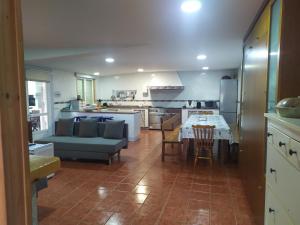 a kitchen with a couch and a table in it at O Pazo in O Grove