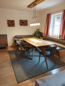 a dining room with a wooden table and chairs at K3 Ferienhaus in Strobl