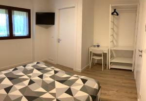 a bedroom with a black and white checkered floor at AI QUATTRO SOLI 