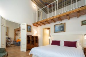 a bedroom with a white bed and a staircase at Palazzo D'Ambra Residenza d'Epoca in Florence