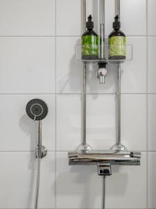 a shower with two lights in a bathroom at 2ndhomes Tampere "Areena" Apartment in Tampere