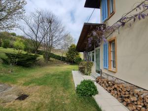 a house with a window and a pile of logs at CASA IL GLICINE in Rocchetta Palafea