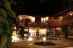 uma casa com piscina à noite em Pousada Enseada dos Búzios em Ubatuba