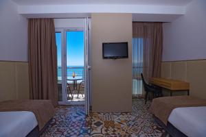 a hotel room with two beds and a view of the ocean at Vila Europa in Struga