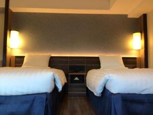 Llit o llits en una habitació de Matsue Excel Hotel Tokyu