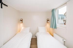 Un ou plusieurs lits dans un hébergement de l'établissement Thalassa Beach Houses