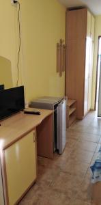a kitchen with a counter and a refrigerator in a room at Вили Бийчхаус in Kranevo