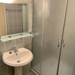 a bathroom with a sink and a glass shower at Carina Beach in Sunny Beach