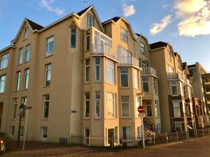 an apartment building in front of a street at Sea view Scheveningen in Scheveningen
