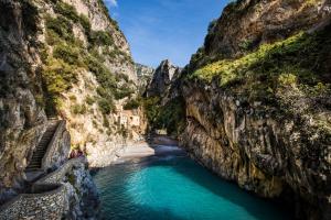 a view of a river between two cliffs at Albergo Diffuso Bacco Furore in Furore