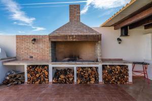 a pile of fire wood in an outdoor fireplace at Villa Gle Apt 1 in Quartu SantʼElena
