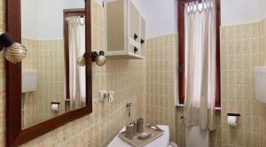 a bathroom with a sink and a mirror and a toilet at Appartamento a Moneglia, tra Portofino e le Cinque Terre in Moneglia +32 photos