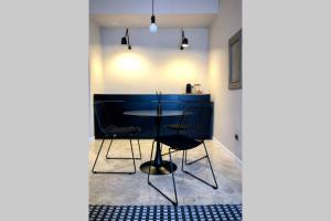a dining room with a table and chairs at laus via sparano - lux & design mini in Bari +5 photos