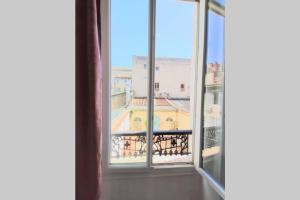 an open window with a view of a building at Le Saint du Vieux Port in Marseille