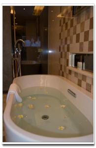 a bath tub with flowers in it in a bathroom at Panyu Hotel in Guangzhou