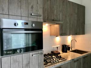 a kitchen with a stove top oven and a sink at Sea view Scheveningen in Scheveningen