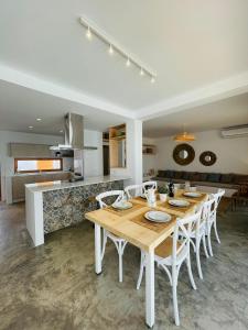 a kitchen and dining room with a wooden table and chairs at Villa Sal - Alvor in Alvor