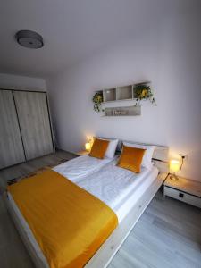 a bedroom with a large bed with yellow sheets at Karra Residence Timisoara - autorizat Ministerul Turismului in Timişoara