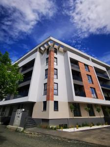 a white building with a red brick at Karra Residence Timisoara - autorizat Ministerul Turismului in Timişoara +55 photos