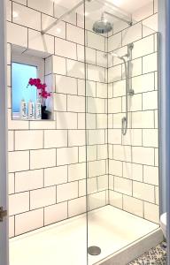 a bathroom with a shower with white subway tiles at Esme's in Winchester