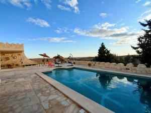 a swimming pool in the middle of a patio at Dar Ayed Tamezret in Tamezret