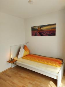 a bed in a room with a painting on the wall at good bed biberist BIBERSOL in Biberist