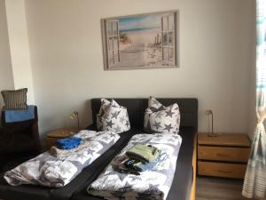 a living room with a couch with pillows at Hotel & Restaurant Neptun in Norddorf