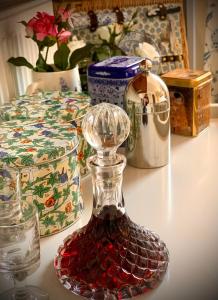 a glass decanter on a counter with other items at Esme's in Winchester