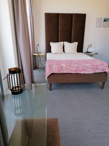 a bedroom with a bed and a glass table at Day Off Suite&Hostel in Setúbal