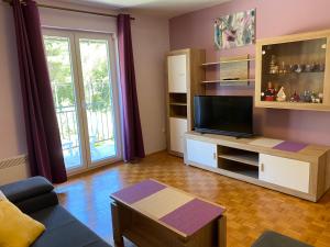 a living room with a couch and a tv at Ivana Apartment in Korčula