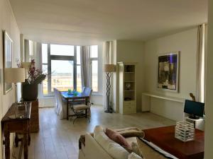 a living room with a couch and a table at Sea view Scheveningen in Scheveningen