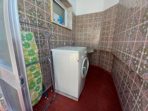 a small bathroom with a washing machine in it at Torre Azul 11 Vista Panoramica in Quarteira +36 photos