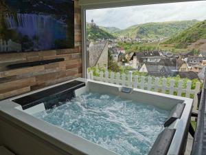 a jacuzzi tub in front of a large window at Anitas Ferienhaus in Cochem