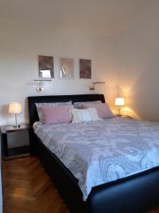 ein Schlafzimmer mit einem großen Bett mit zwei Lampen in der Unterkunft Apartments M Gregor ideal for relaxing holidays in Baška