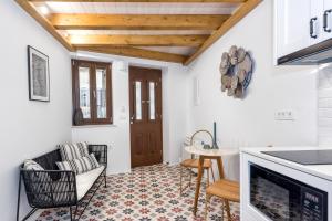 a living room with a kitchen and a table at Casa Livieres in Chania Town