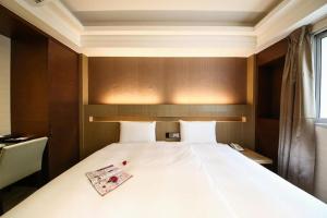 Postel nebo postele na pokoji v ubytování Talmud Hotel Tainan