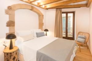 a bedroom with a large white bed and a chair at Casa Livieres in Chania Town