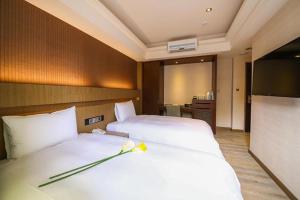 Postel nebo postele na pokoji v ubytování Talmud Hotel Tainan