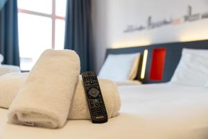 a remote control sitting on top of a bed at easyHotel Oxford in Oxford