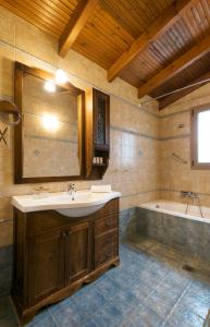 a bathroom with a sink and a bath tub at Sanidiamonds in Sani Beach