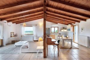 a living room and kitchen with a large wooden ceiling at Sanidiamonds in Sani Beach