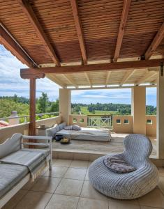 a room with a bed and a couch and chairs at Sanidiamonds in Sani Beach