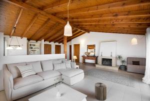 a living room with a couch and a fireplace at Sanidiamonds in Sani Beach