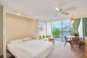 A bed or beds in a room at Napili Sunset Beach Front Resort