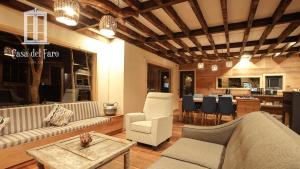 a living room with a couch and chairs and a table at Casa del Faro Chiloé in Castro