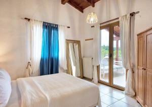 a bedroom with a bed and a sliding glass door at Sanidiamonds in Sani Beach