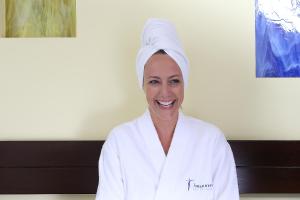 a woman with a towel on her head in a room at Johannesbad Hotel Phönix in Bad Füssing