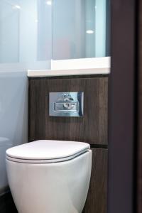 a bathroom with a white toilet and a sink at easyHotel Oxford in Oxford +12 photos