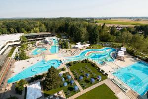 an aerial view of a resort with two pools at Johannesbad Hotel Phönix in Bad Füssing
